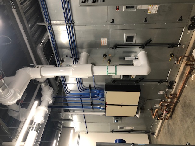 Commercial mechanical room with HVAC controls and conduit
