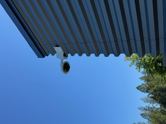 Exterior dome surveillance camera installed on a commercial or public-sector building
