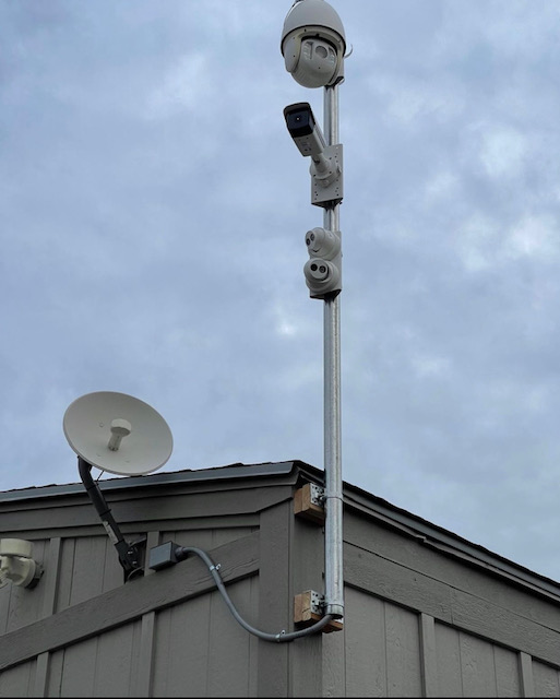 Exterior surveillance camera system mounted on a pole for property coverage