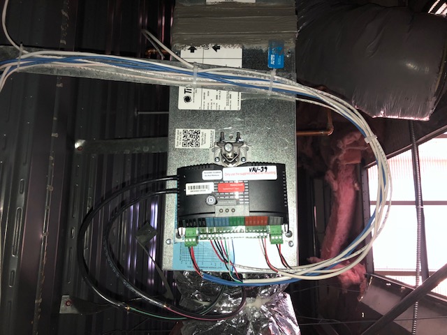 HVAC control board installation above a building ceiling