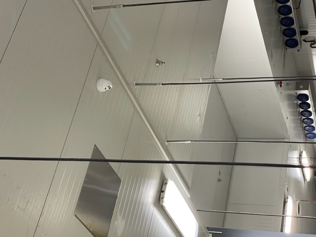 Interior security camera mounted above an exit door